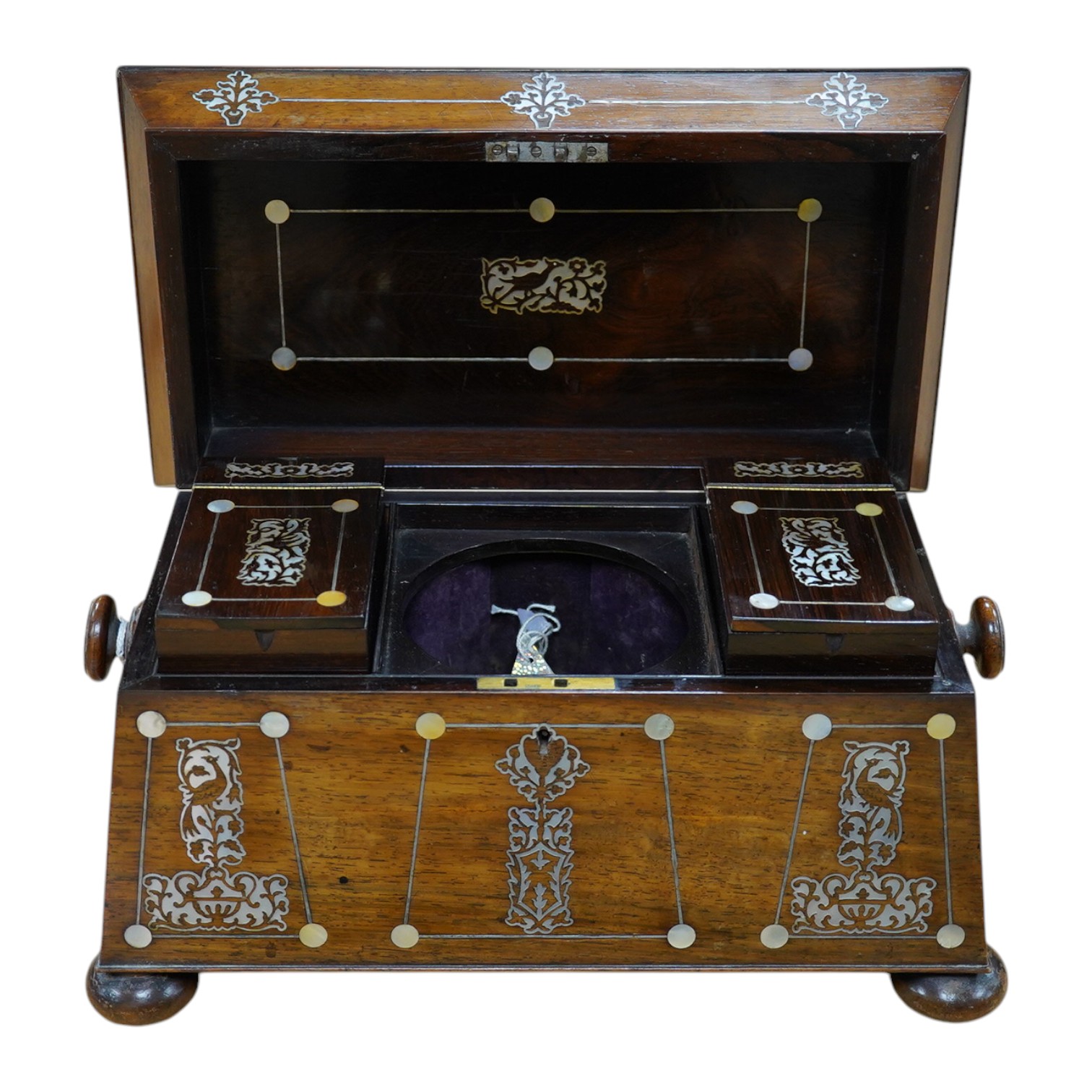 A Victorian rosewood and mother-of-pearl inlaid sarcophagus tea caddy, 39cm wide. Condition - fair